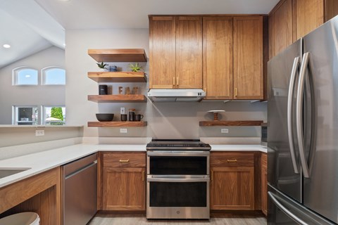 a kitchen with stainless steel appliances and wooden cabinets