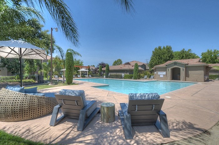 Pool with Lounge Chair Seating | Stonelake Apartments in Elk Grove, California