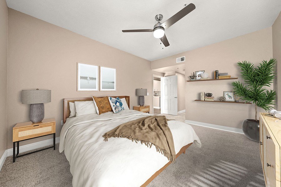 a bedroom with a bed and a ceiling fan
