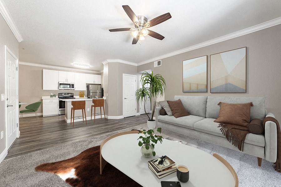 an open living room and kitchen with a couch and a coffee table