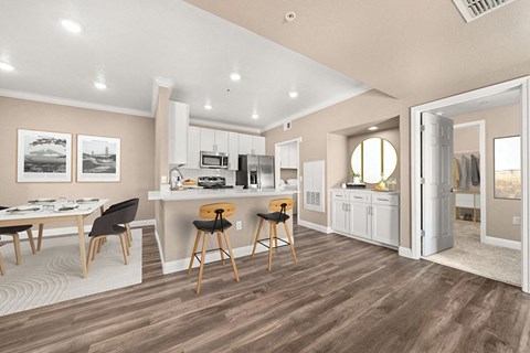 a kitchen and dining room with a refrigerator and a table and chairs