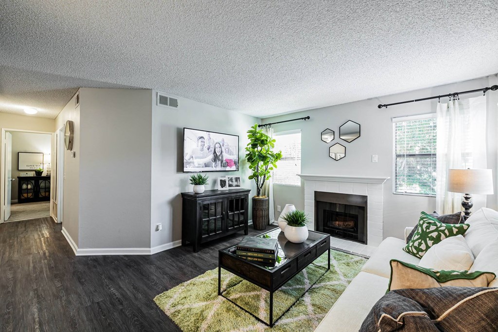an open living room with a fireplace and a couch at SYCAMORE GREENS APARTMENT HOMES, California, 92081