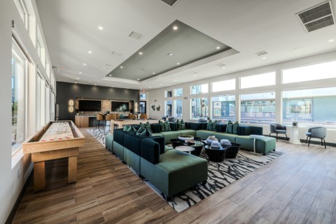 a large room with couches tables and chairs and a pool table at SYNC APARTMENT HOMES, North Las Vegas, 89084