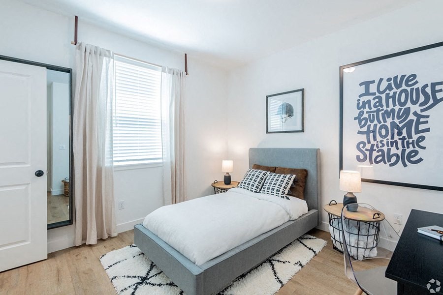 Homes for Rent Near Riverview - Crocker Village - Bedroom with Wood-Style Flooring, a Window, and Stylish Decor