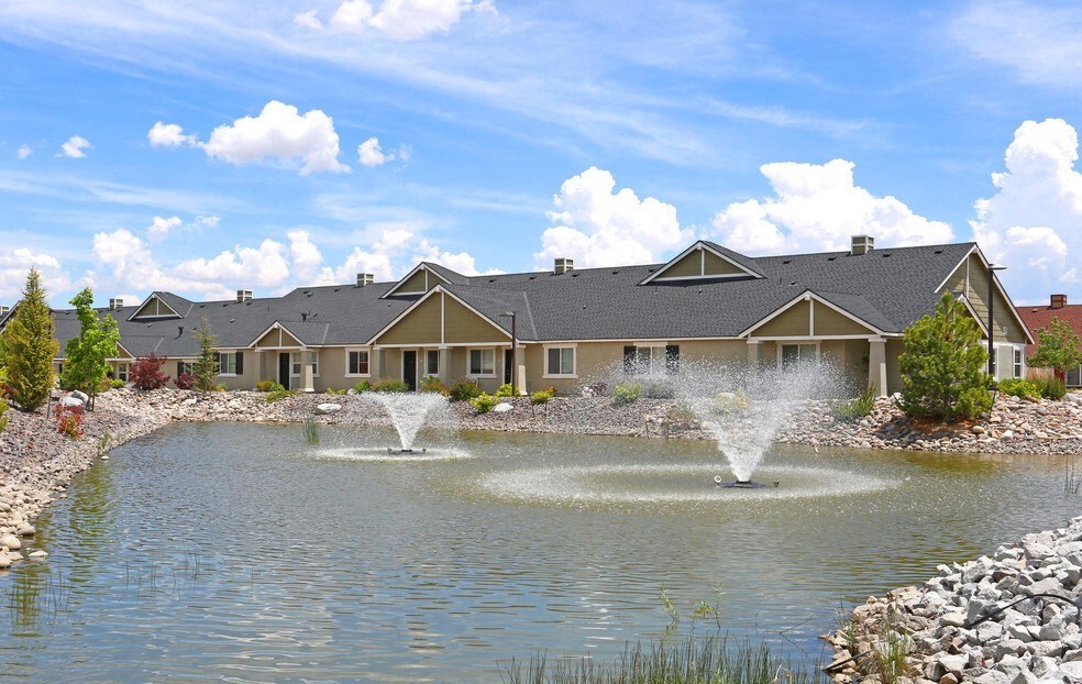 One BR Apartments in Reno NV - Bungalows at Sky Vista - Pond Surrounded by Rocks with Water Features in the Middle.