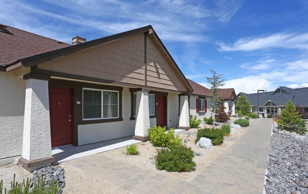 the front of a house with a walkway and landscaping
