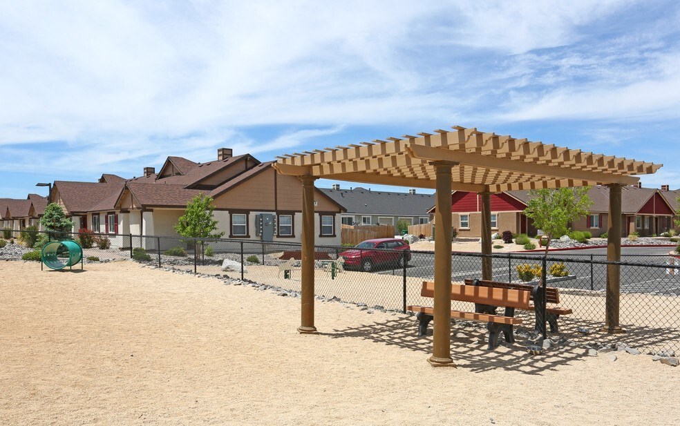 a playground with a picnic table and a pergola