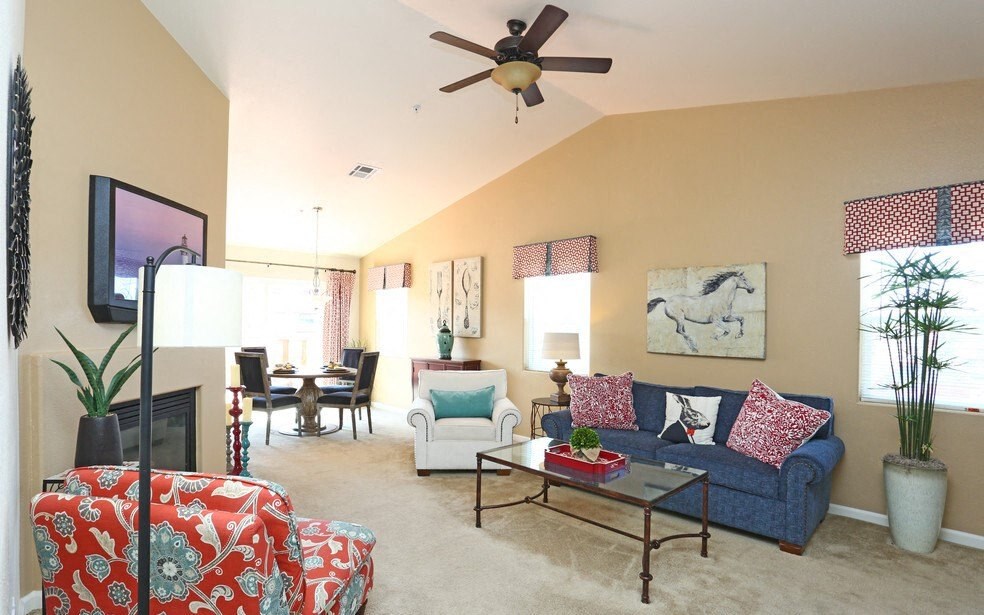 a living room with a couch and a ceiling fan