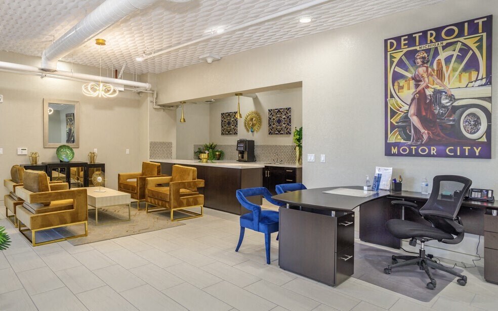 the lobby of a motor city motor city dealership with a desk and chairs