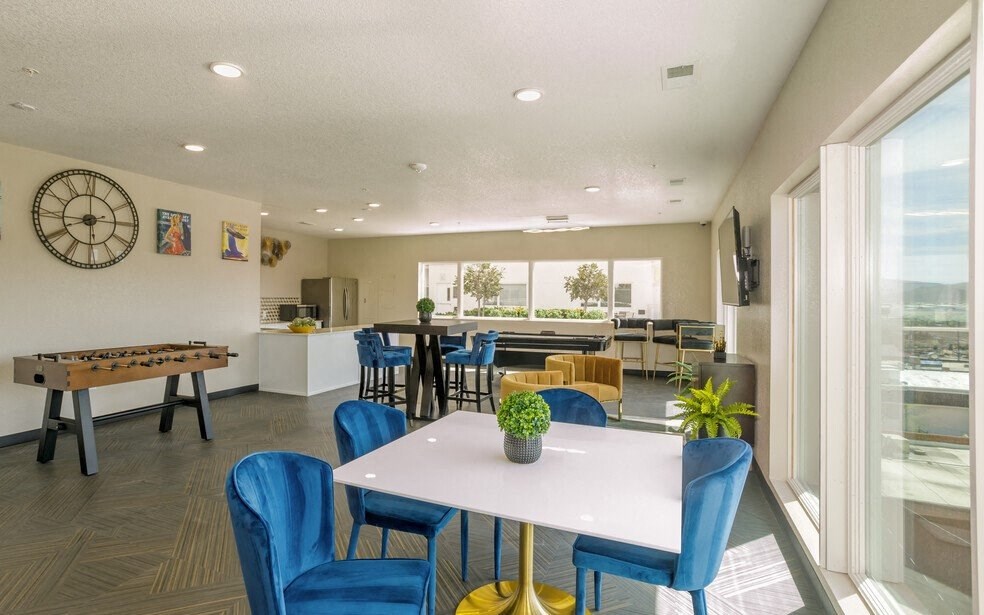 a game room with a foosball table and chairs