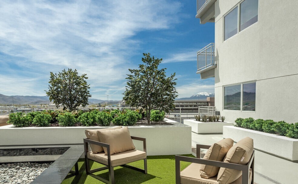 Sparks, NV Apartments - The Deco - Patio with Comfortable Chairs, Beautiful Landscaping, and Views of the City