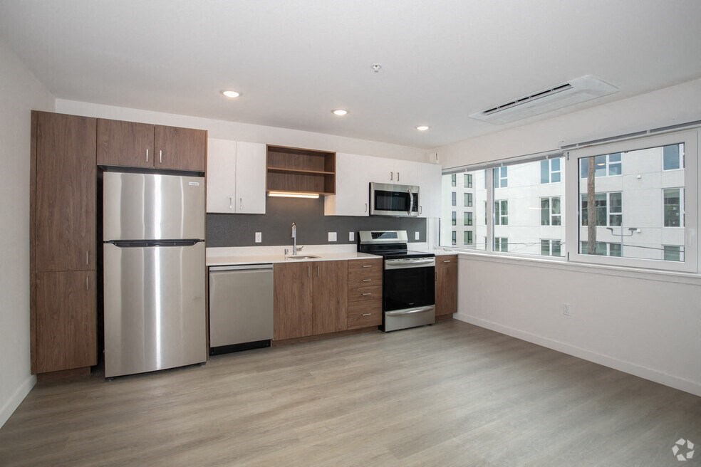 Midtown Sacramento, CA Apartments - Mod at Midtown - Modern Kitchen with Stainless Steel Appliances, Two-Tone Cabinetry, Quartz Countertops, Induction Cooktop, Plank Wood Flooring, and Wall to Wall Windows