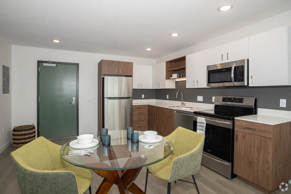 a kitchen and dining room with a table and chairs at THE MOD AT MIDTOWN Apartments, SACRAMENTO