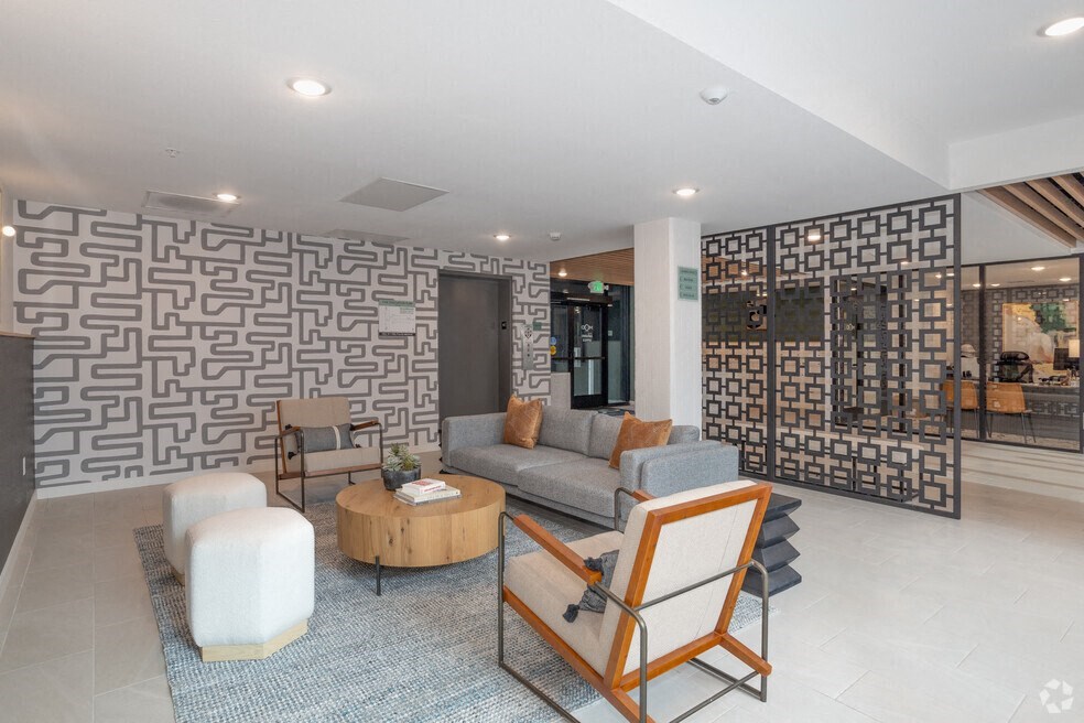 a living room with a couch and chairs and a wall with an oriental design at THE MOD AT MIDTOWN Apartments, SACRAMENTO, California