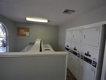 an empty room with white cabinets and a counter at DESERT PEAKS, EL PASO