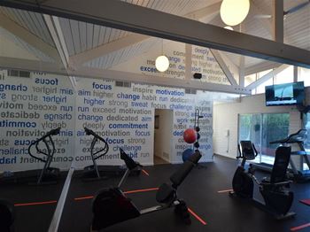 a gym with a lot of exercise equipment at DESERT PEAKS, EL PASO