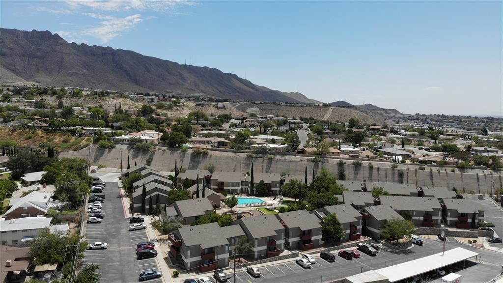 an aerial view of a neighborhood with a mountain in the background at DESERT PEAKS, EL PASO, 79912