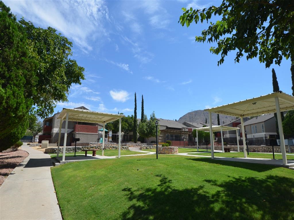 a park with green grass and pavilions at DESERT PEAKS, EL PASO