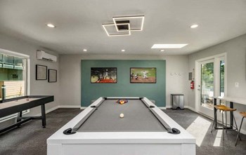 Vacaville Apartments - The Parc- Game Room with a Pool Table and an Air Hockey Table - Photo Gallery 3