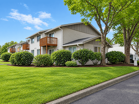 Towncenter Exterior building with green bushes and a tree in front.