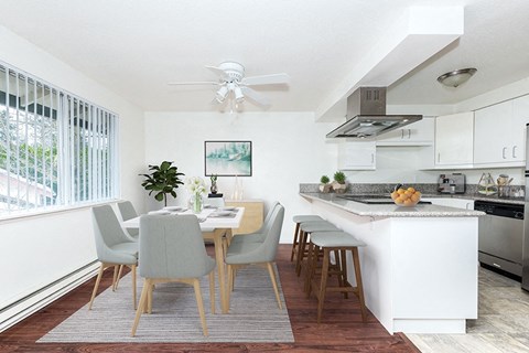an open kitchen and dining room with a table and chairs