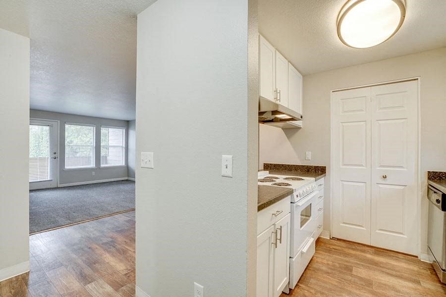 Kitchen with appliances near living room at TOWNSHIP Apartments, CANBY, Oregon