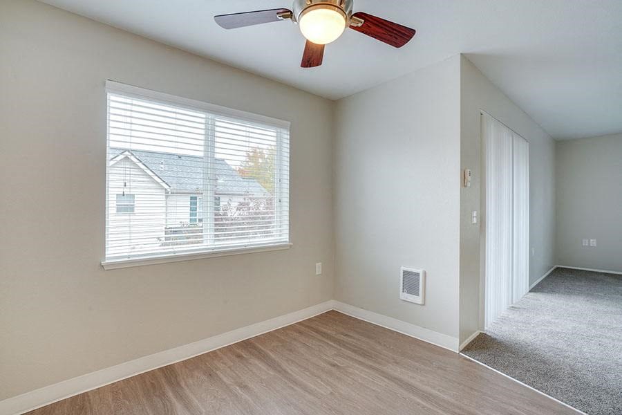 Living room with windows at TOWNSHIP Apartments, CANBY, OR