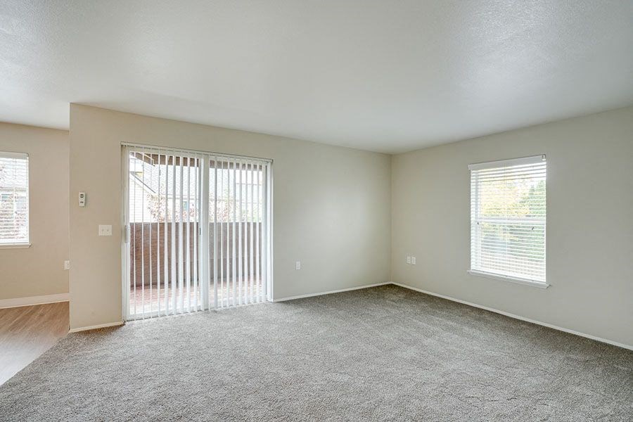 Living room with window and patio at TOWNSHIP Apartments, CANBY