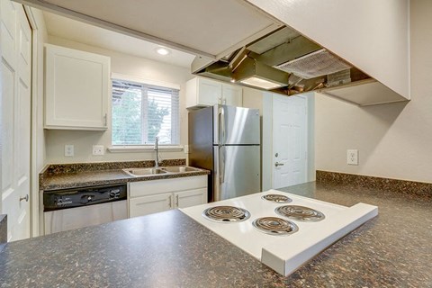 a kitchen with a stove and a refrigerator