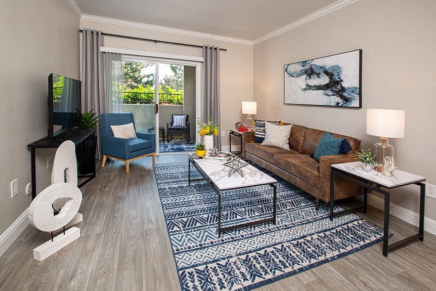 Apartments in Spanish Springs for Rent - High Rock 5300 - Well Lit Living Room with Attached Balcony, Glass Sliding Doors, and Wood Plank Flooring