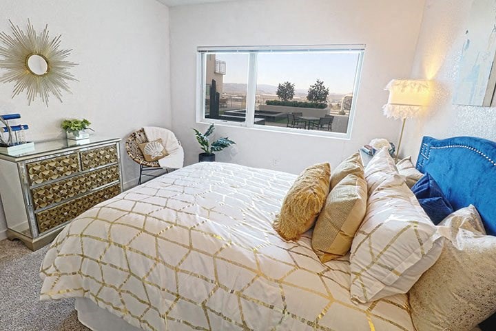 Two-Bedroom Apartments in Sparks, NV- Deco at Victorian Square- Large Window with Mirror Drawers and Comfortable Bed