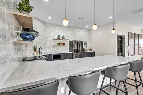 the kitchen has a large island with four chairs