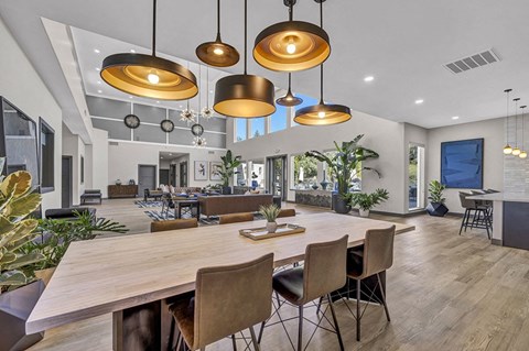 a large dining room with a wooden table and chairs