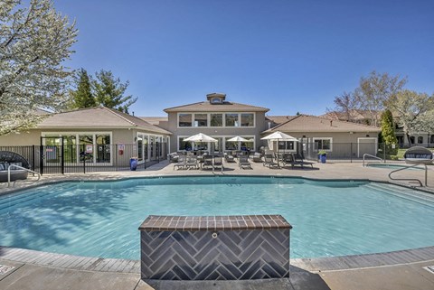 a swimming pool with a house in the background