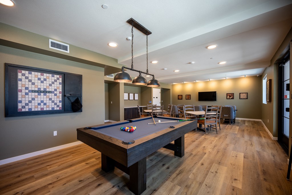 a games room with a pool table and a tv at Vintage at Anacapa Canyon, Camarillo, CA