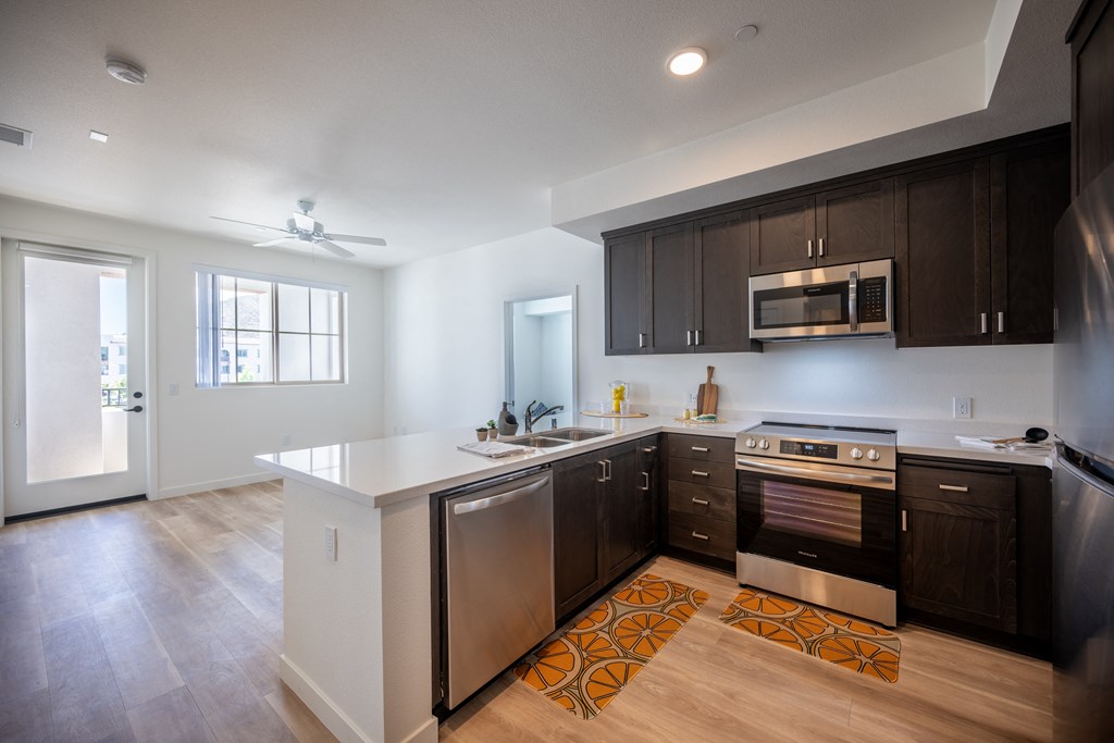 a kitchen with a white counter top and dark cabinets at Vintage at Anacapa Canyon, California 93012