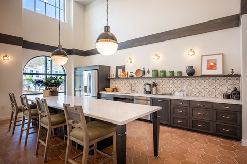 a kitchen with a white table and chairs and a counter top
