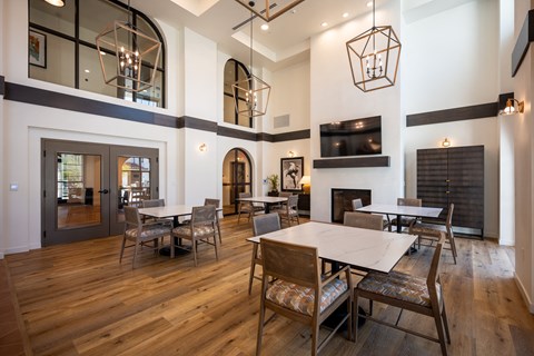a dining room with tables and chairs and a fireplace at Vintage at Anacapa Canyon, Camarillo, California