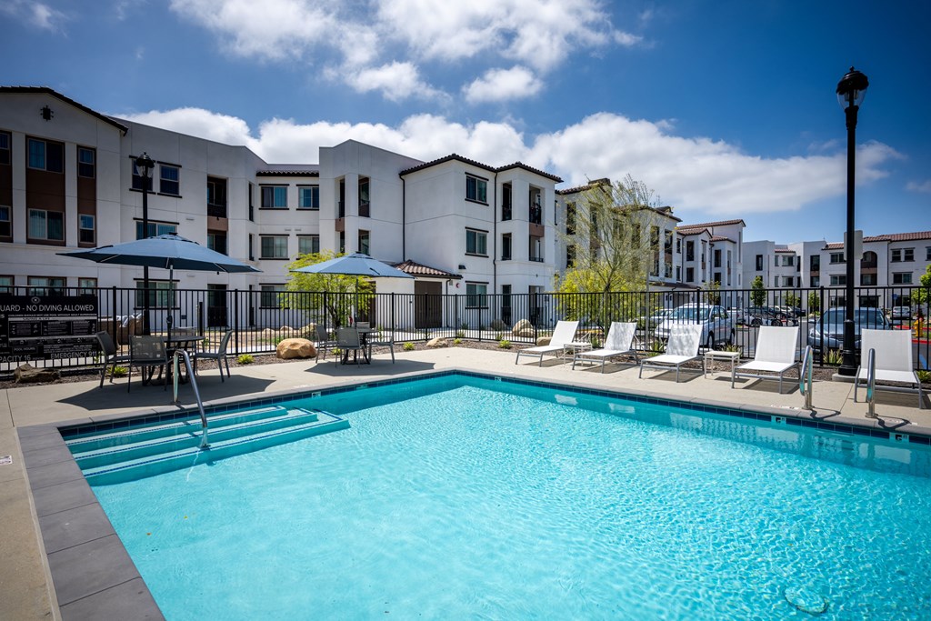our apartments have a swimming pool with chairs and umbrellas at Vintage at Anacapa Canyon, Camarillo, California