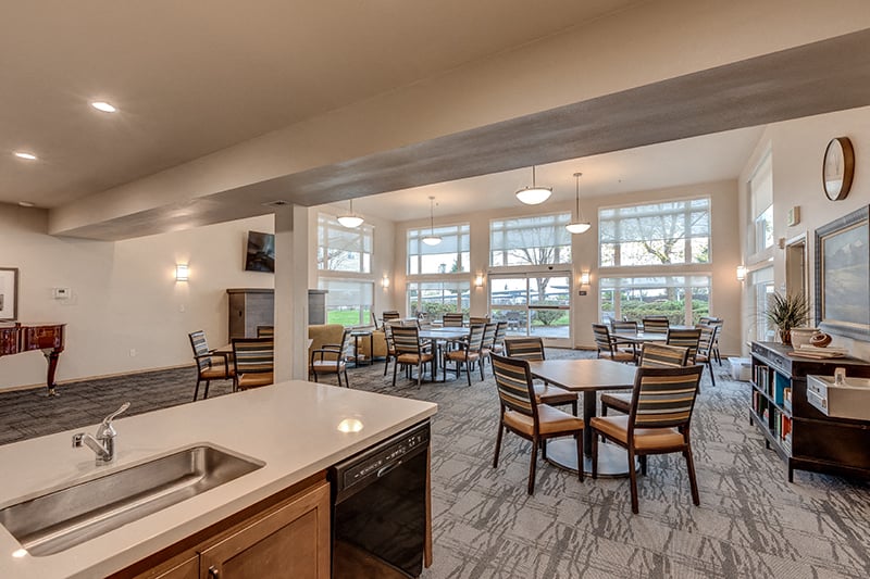 A kitchen with a dining table and chairs.