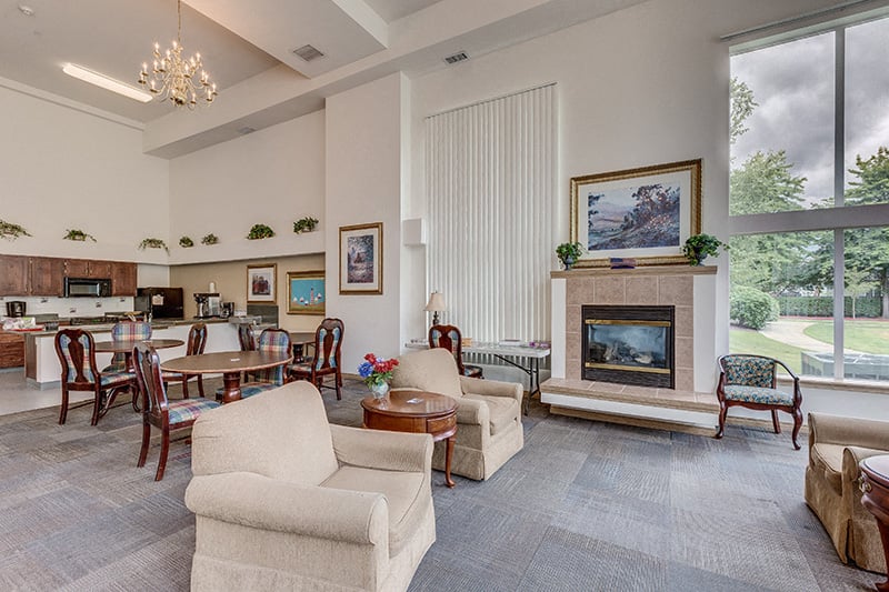 A living room with a fireplace and a painting on the wall.