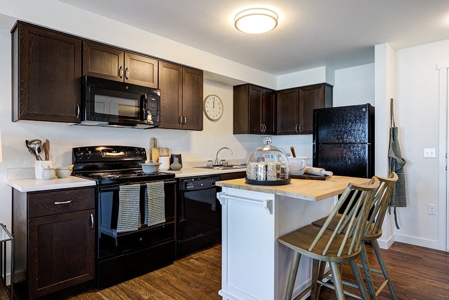 Apartments for Rent in Des Moines, WA - Pointe By Vintage Kitchen With Black Appliances, and Modern Wood Cabinets