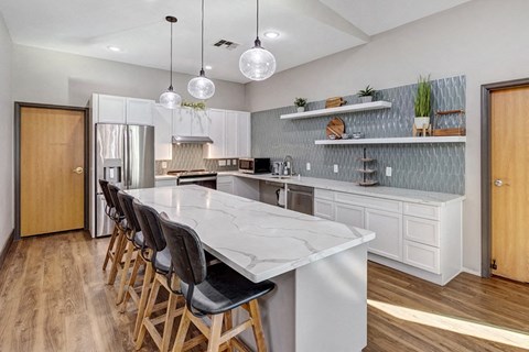 a large kitchen with a marble counter top