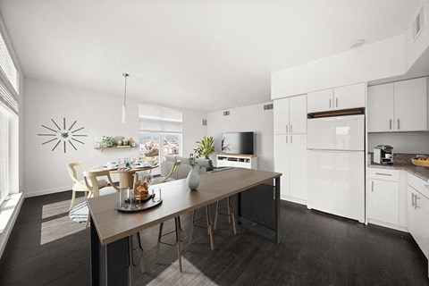 A modern kitchen with a dining table and chairs.