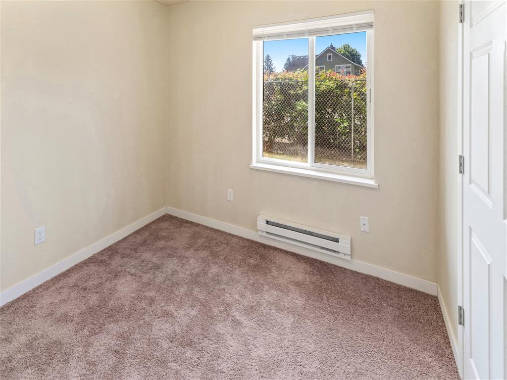 an empty room with a window and a radiator at Webster Court Senior Apartments, Washington, 98032