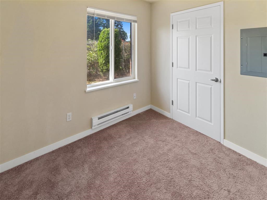 an empty room with a white door and window at Webster Court Senior Apartments, Kent