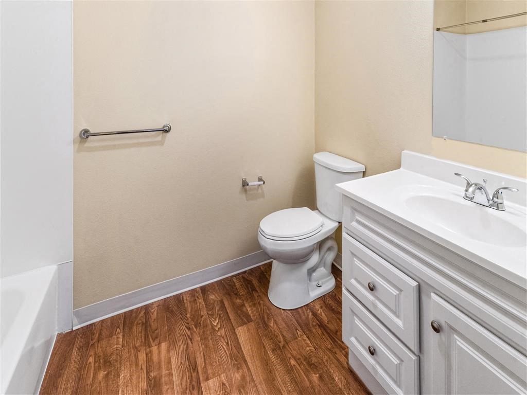 a bathroom with a toilet sink and bathtub at Webster Court Senior Apartments, Washington