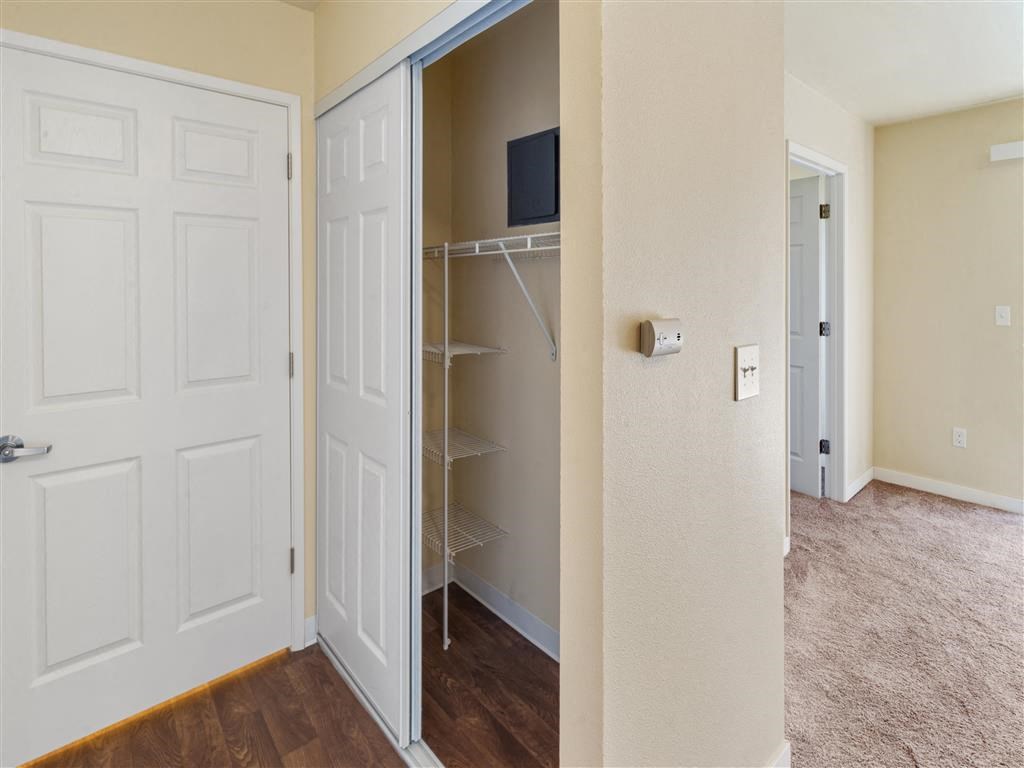 a bedroom with a closet and a door that is open at Webster Court Senior Apartments, Kent, 98032