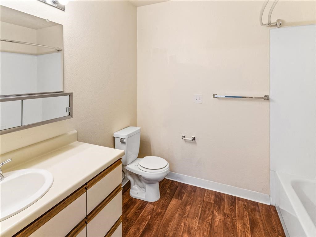 a bathroom with a toilet sink and bathtub at Webster Court Senior Apartments, Kent, WA
