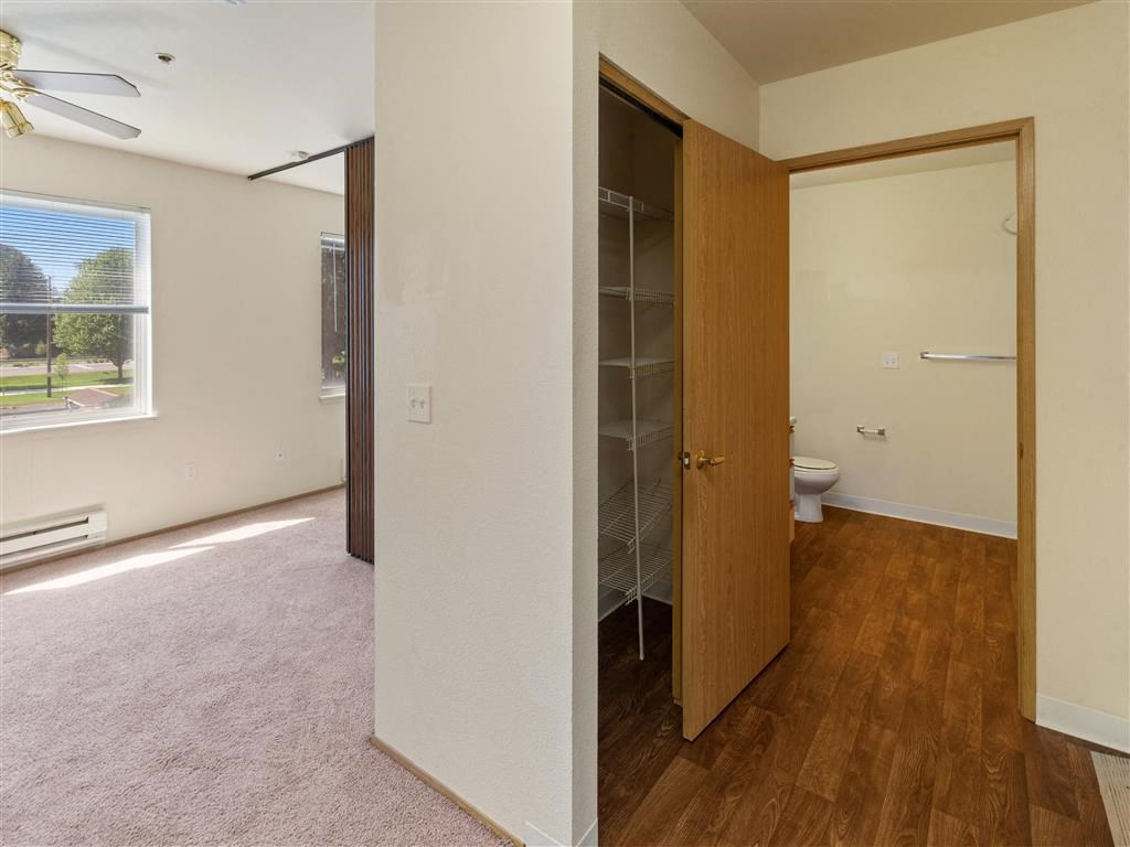 an empty room with a door open to a bathroom at Webster Court Senior Apartments, Kent, 98032